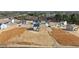 Aerial view of a neighborhood featuring a modern white home with a wooden porch and large yard at 35 Diamond Creek Dr, Zebulon, NC 27597