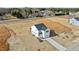 Aerial view of new home featuring a front-facing garage, lawn and a long concrete driveway at 35 Diamond Creek Dr, Zebulon, NC 27597