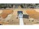 Aerial view showcasing a white two-story home with a front-facing garage and a long concrete driveway at 35 Diamond Creek Dr, Zebulon, NC 27597
