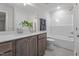 Bright bathroom features a tub with shower, tile floors, and a wooden vanity with a white countertop at 35 Diamond Creek Dr, Zebulon, NC 27597