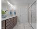 Bathroom featuring double vanity sinks, modern lighting, and a glass-enclosed shower at 35 Diamond Creek Dr, Zebulon, NC 27597