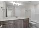 Bathroom with gray cabinetry, undermount sink and large mirror at 35 Diamond Creek Dr, Zebulon, NC 27597