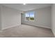 Spacious carpeted bedroom with a large window providing natural light and scenic outdoor views at 35 Diamond Creek Dr, Zebulon, NC 27597
