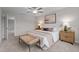Comfortable bedroom with a large window, ceiling fan, and stylish bench at the foot of the bed at 35 Diamond Creek Dr, Zebulon, NC 27597