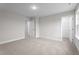 Bright bedroom has neutral paint, carpeted floor, and two entryways, one to a closet, another to a hallway at 35 Diamond Creek Dr, Zebulon, NC 27597