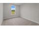 Bright bedroom with a large window offering views of greenery and a ceiling fan at 35 Diamond Creek Dr, Zebulon, NC 27597