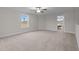 Spacious bedroom with large window and doorway to landing area; ceiling fan included at 35 Diamond Creek Dr, Zebulon, NC 27597