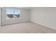 An empty carpeted bedroom is brightened with a window view at 35 Diamond Creek Dr, Zebulon, NC 27597