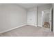 Bedroom featuring double door closets, carpeted floors, and neutral-colored walls at 35 Diamond Creek Dr, Zebulon, NC 27597