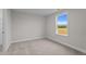 Neutral bedroom features carpeted floor and a double hung window with a view of an adjacent field at 35 Diamond Creek Dr, Zebulon, NC 27597