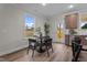 Bright dining area featuring a round table with seating, wood floors, and a view of the backyard at 35 Diamond Creek Dr, Zebulon, NC 27597