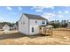 White two-story home with a welcoming wooden porch and a well-manicured lawn at 35 Diamond Creek Dr, Zebulon, NC 27597