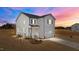 Charming two-story home featuring vinyl siding, black shutters, a welcoming front porch, and an attached garage at 35 Diamond Creek Dr, Zebulon, NC 27597