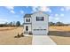 Charming two-story home featuring vinyl siding, black shutters, a welcoming front porch, and an attached garage at 35 Diamond Creek Dr, Zebulon, NC 27597