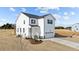 Charming two-story home featuring vinyl siding, black shutters, a welcoming front porch, and an attached garage at 35 Diamond Creek Dr, Zebulon, NC 27597