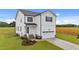 Beautifully landscaped two-story home with white siding, black shutters and door, plus a two-car garage at 35 Diamond Creek Dr, Zebulon, NC 27597
