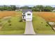 Aerial front exterior view of a white two-story house with a two-car garage and a long driveway at 35 Diamond Creek Dr, Zebulon, NC 27597