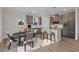 Modern kitchen with stainless steel appliances, a central island with counter seating, and an adjacent dining area at 35 Diamond Creek Dr, Zebulon, NC 27597