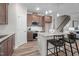 Modern kitchen features stainless steel appliances, granite countertops, dark wood cabinets, and island with barstool seating at 35 Diamond Creek Dr, Zebulon, NC 27597