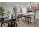 Open concept kitchen and dining area featuring stainless appliances, granite counters, and modern furnishings at 35 Diamond Creek Dr, Zebulon, NC 27597