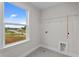 Laundry room features tile floor, a window, and utility connections at 35 Diamond Creek Dr, Zebulon, NC 27597