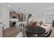 Open concept living area with kitchen, dining space, and living room with staircase and wood floors at 35 Diamond Creek Dr, Zebulon, NC 27597