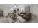 Spacious living room with lots of natural light, neutral walls, a patterned rug and stylish decor at 35 Diamond Creek Dr, Zebulon, NC 27597