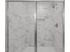 Modern shower with marble-style tile and glass door at 35 Diamond Creek Dr, Zebulon, NC 27597