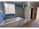 Modern bathroom showcasing a tiled shower, large window, and a soaking tub at 9148 Dupree Meadow Dr # 11, Angier, NC 27501