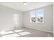 Bright bedroom featuring neutral carpet, a double window offering views of the neighborhood and white trim at 9148 Dupree Meadow Dr # 11, Angier, NC 27501