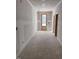 Hallway view showcasing an entry door, neutral paint, and an open doorway at 9148 Dupree Meadow Dr # 11, Angier, NC 27501