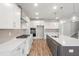 Bright kitchen features stainless appliances, white cabinets, and center island at 9148 Dupree Meadow Dr # 11, Angier, NC 27501