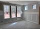 Bright living room featuring large windows with natural light and unfinished neutral paint at 9148 Dupree Meadow Dr # 11, Angier, NC 27501