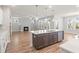 Open floor plan with kitchen island open to the living room and fireplace at 9148 Dupree Meadow Dr # 11, Angier, NC 27501