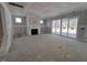 Unfinished living room with fireplace and sliding glass doors to backyard at 9148 Dupree Meadow Dr # 11, Angier, NC 27501