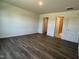 Large bedroom showcasing hardwood floors with views to walk-in closet and bathroom at 111 Johnson Ridge Way, Four Oaks, NC 27524