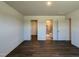 Spacious bedroom with hardwood floors and view of walk-in closet and bathroom at 111 Johnson Ridge Way, Four Oaks, NC 27524