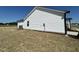 A side view showcases the home's exterior, with a neat lawn, white siding, and black gutters at 111 Johnson Ridge Way, Four Oaks, NC 27524