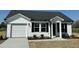Charming single-story home featuring a white facade, black shutters, and a well-manicured lawn at 111 Johnson Ridge Way, Four Oaks, NC 27524