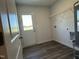 A spacious laundry room with vinyl floors, wire rack shelving and a door to the outside at 111 Johnson Ridge Way, Four Oaks, NC 27524
