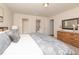 Cozy bedroom with a queen bed, nightstand, and dresser with a mirror at 111 Johnson Ridge Way, Four Oaks, NC 27524
