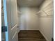 Walk-in closet featuring wire shelving and hardwood floors at 111 Johnson Ridge Way, Four Oaks, NC 27524