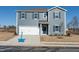 Two-story home with gray siding, white garage door, and landscaping at 147 White Birch Ln, Angier, NC 27501