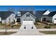 Charming home with a two-car garage, grey siding, and a well-manicured front yard at 2281 Abbeyhill Dr # 136, Raleigh, NC 27610