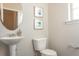 Charming half bathroom with pedestal sink, oval mirror, and elegant wall decor at 259 Johnson Ridge Way, Four Oaks, NC 27524