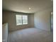 Bright, spacious bedroom with a large window and neutral carpeting, offering a serene and comfortable atmosphere at 259 Johnson Ridge Way, Four Oaks, NC 27524