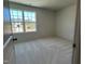 Bedroom with carpet floors, window, and a view of a construction site in the background at 259 Johnson Ridge Way, Four Oaks, NC 27524