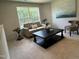 Cozy bonus room with comfortable seating, a stylish coffee table, and large window views at 259 Johnson Ridge Way, Four Oaks, NC 27524
