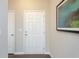 A welcoming entryway featuring crisp white doors and contemporary artwork at 259 Johnson Ridge Way, Four Oaks, NC 27524