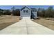 Charming two-story home with a garage and a long driveway on a sunny day at 259 Johnson Ridge Way, Four Oaks, NC 27524